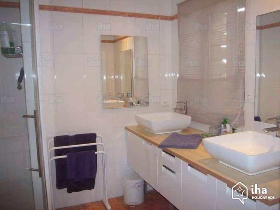 Worst Home Improvements for ROI - A White and Black Accented Mid-Range Bathroom Picture