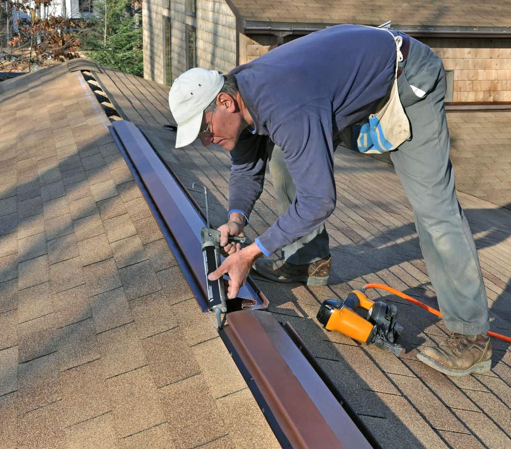 What is the Best Roof Vent for a House - A Roofer Installing Ridge Vent on the Roof of a House