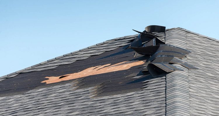 Will Insurance FIx a Leaking Roof? - A Picdture of a Roof with the Shingles Peeled Back