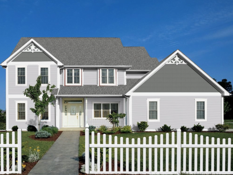 Siding Contractors St Paul MN - A Cream-Colored House with a Gray Roof a Pickett Fence in Front