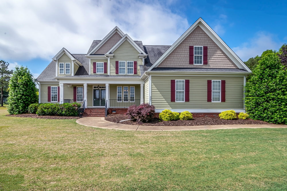 A house with vinyl siding and light green wall color