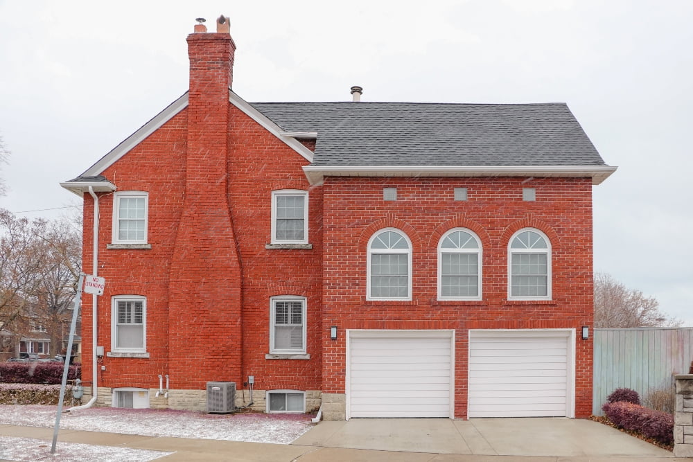 a house made from bricks with white framed windows