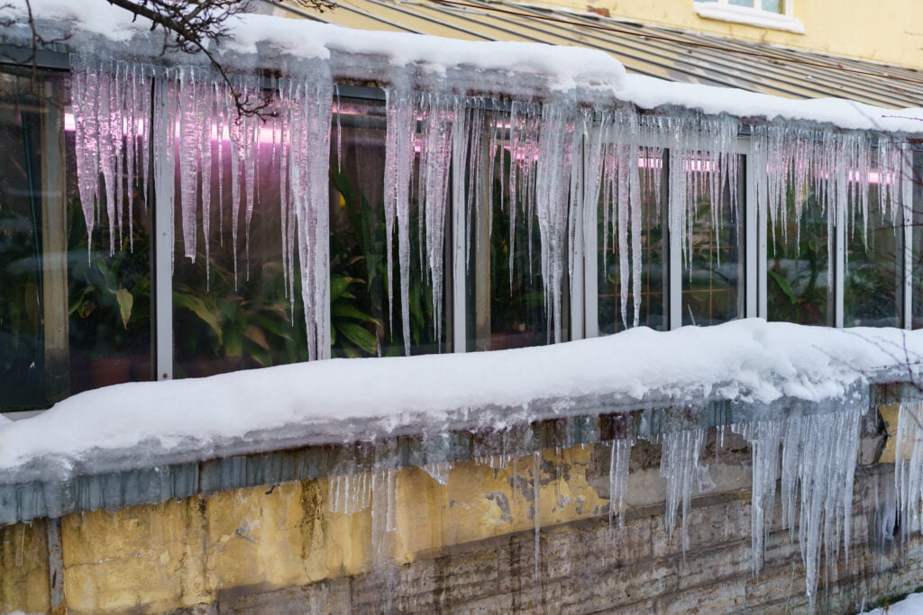 Why is Hail Damage Bad for a Roof? A Roof with Icicles Hanging off.