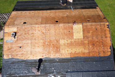 "Roofers replacing shingles on a residential home