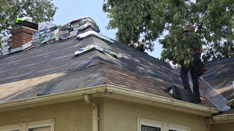 Expert roofers working on a residential roof installation in Minnesota.